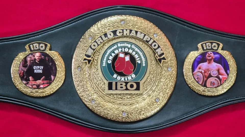 Custom championship belt plate with a boxer's photo and name etched into the metal
