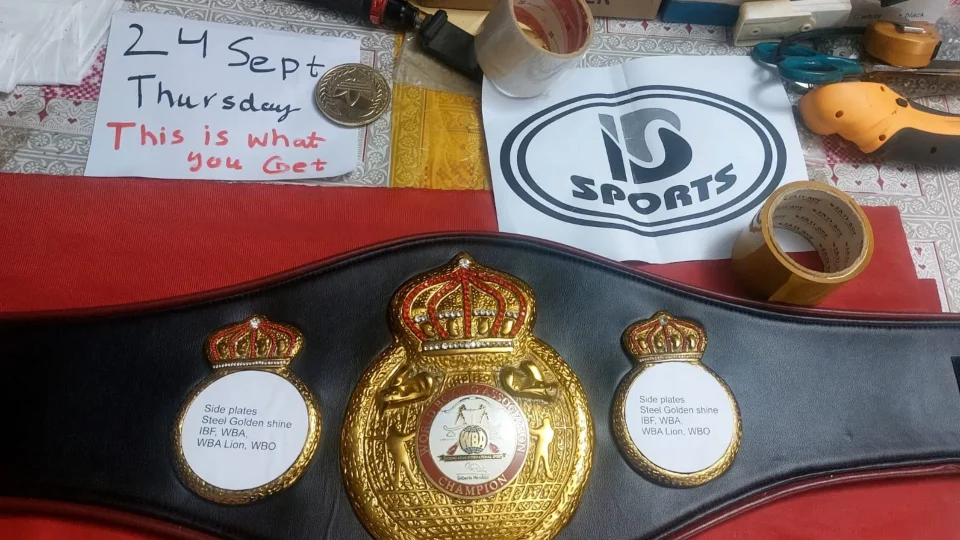 Row of in stock full size replica boxing belts with a handwritten name and date card for buyer proof