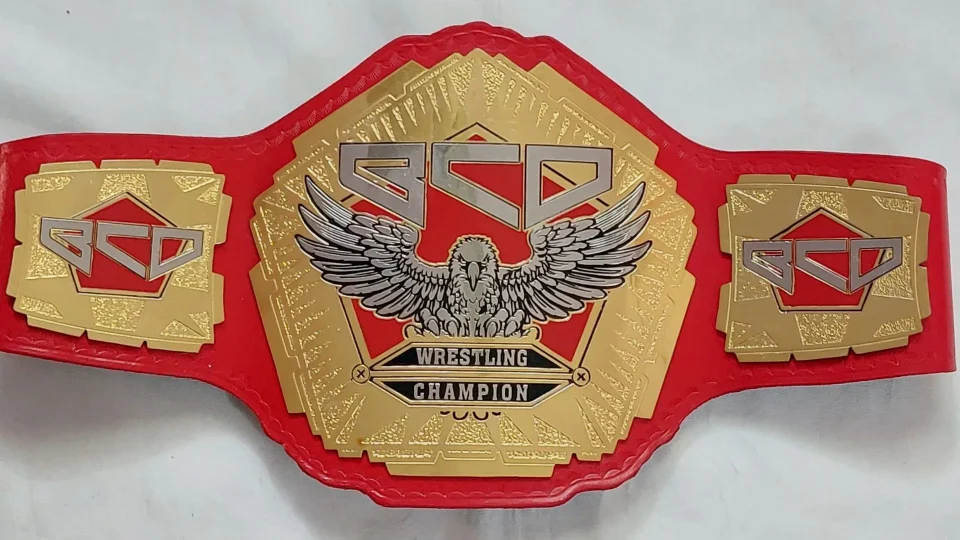 Cheap custom championship belt with etched brass plates on a workbench in Sialkot