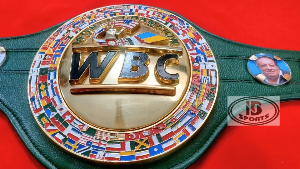 Craftsman hand painting tiny flags on a WBC style belt plate with a fine brush in a Sialkot workshop