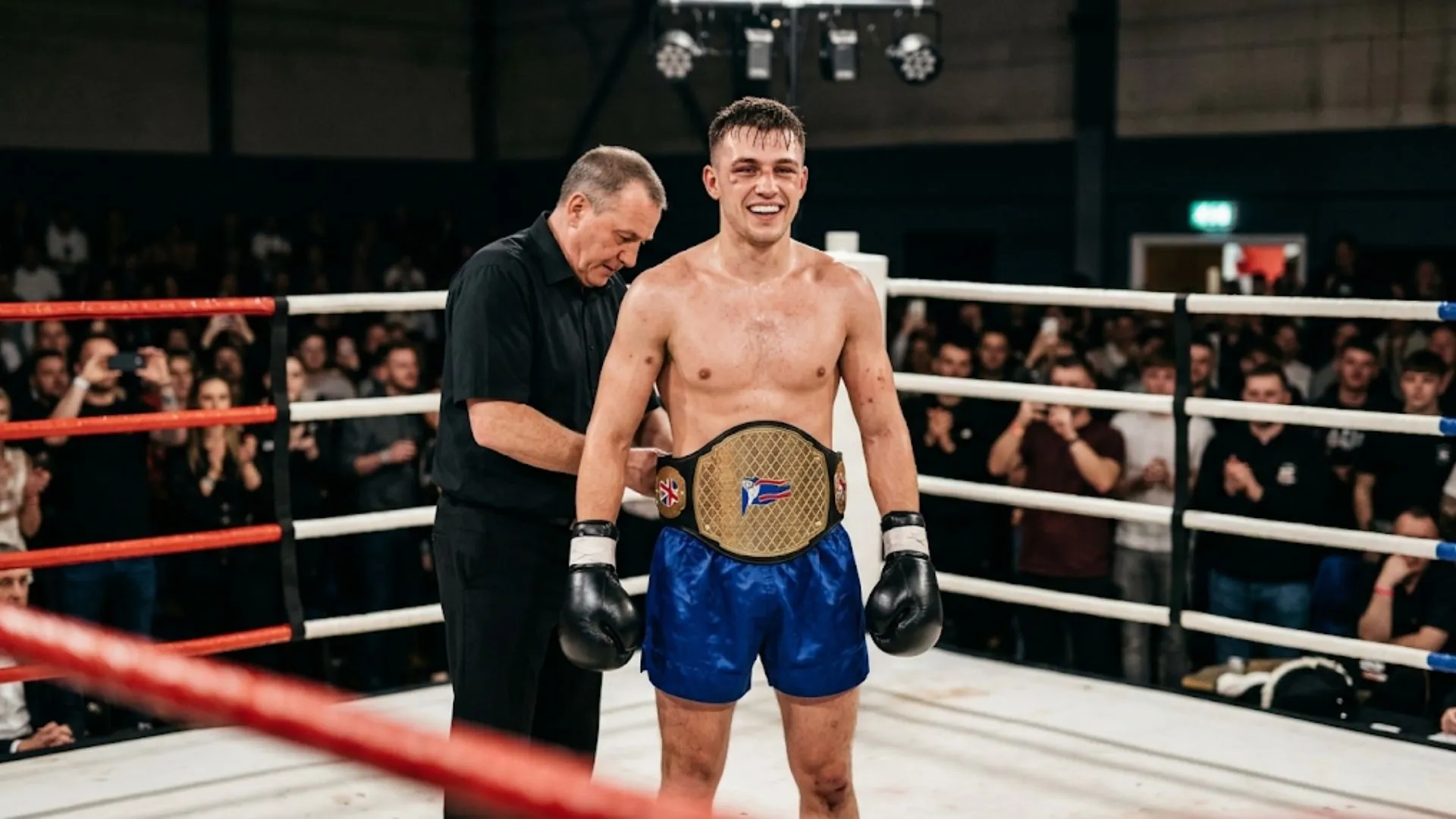 Amateur kickboxer having a championship belt fastened around the waist in the ring after a title fight